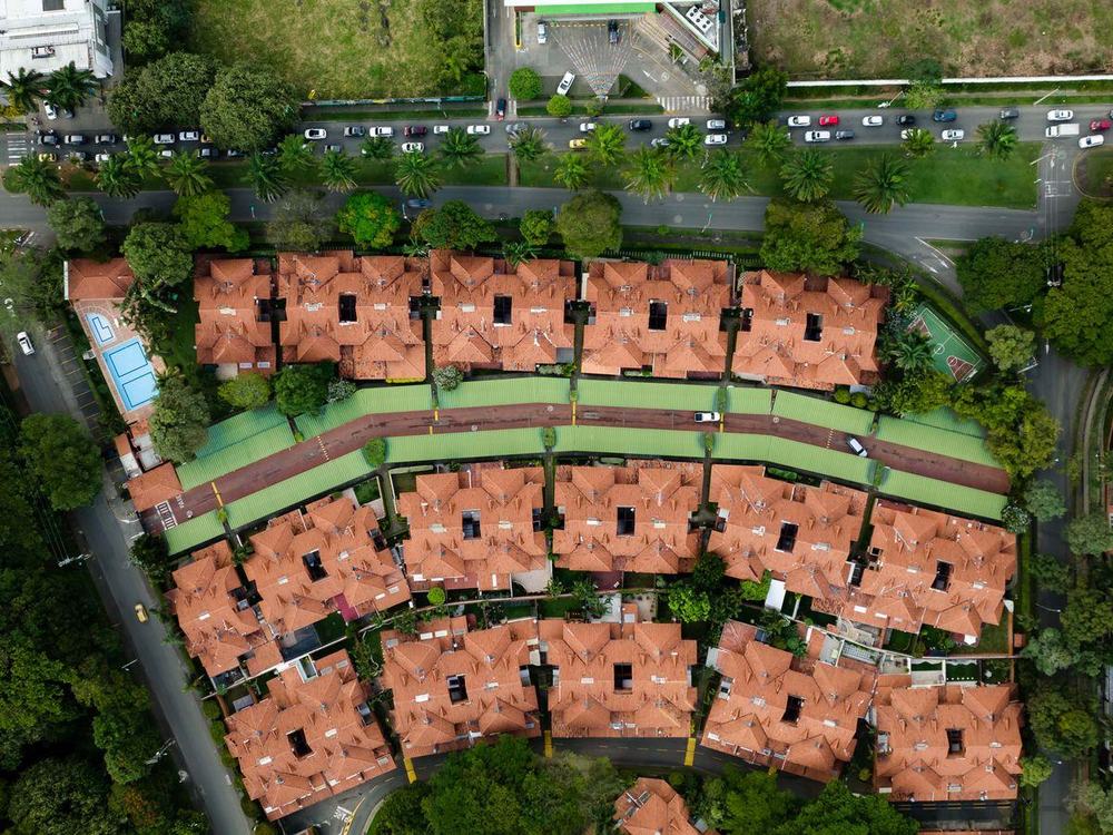 Rows of tiled rooftops in a residential development, seen from above
