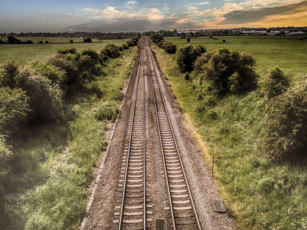 A railway line running straight through open countryside