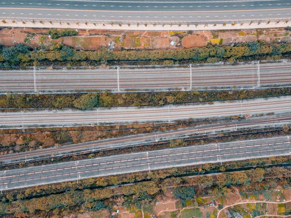 Parallel tracks and carriageways running side by side, seen from above
