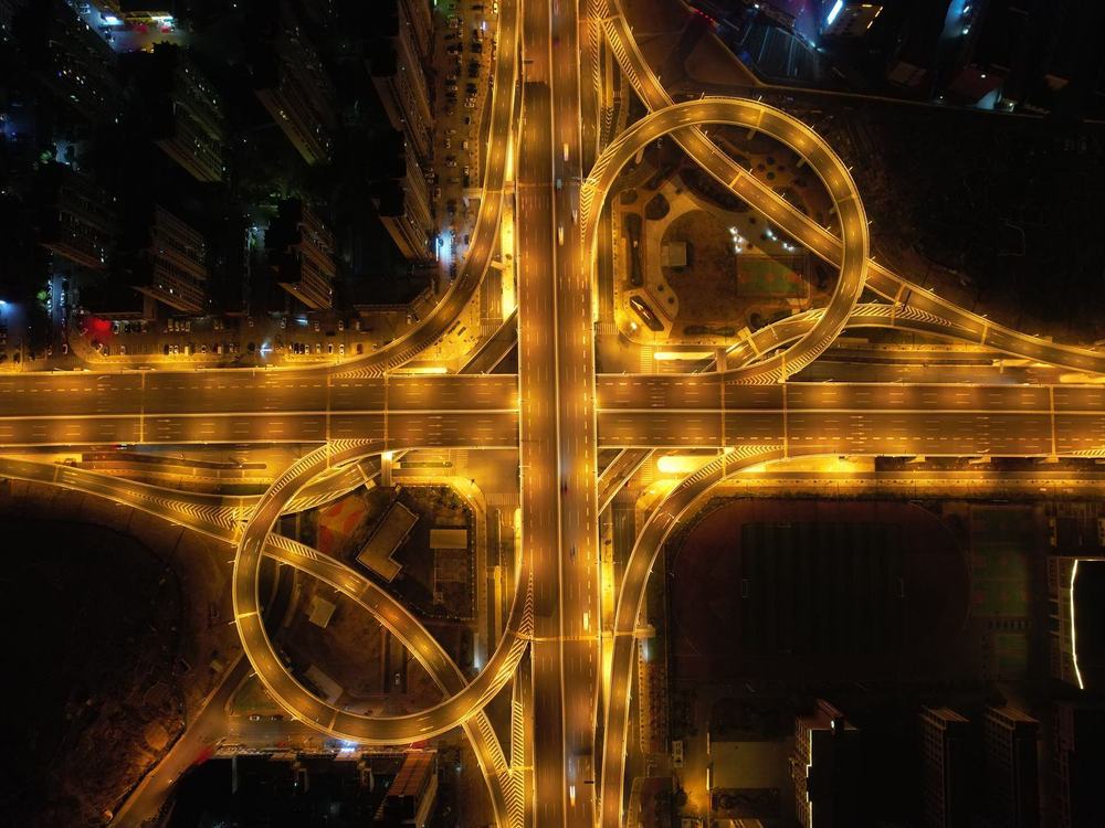 A multi-level highway interchange lit up at night