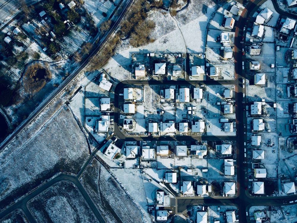 A residential street under snow, seen from directly above