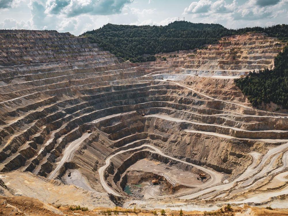 Terraced benches cut into the side of an open-pit mine