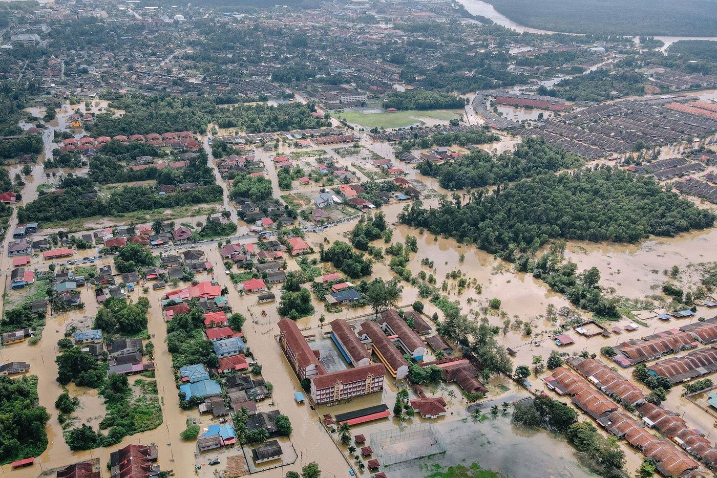 An aerial view of a town with its streets and houses under floodwater
