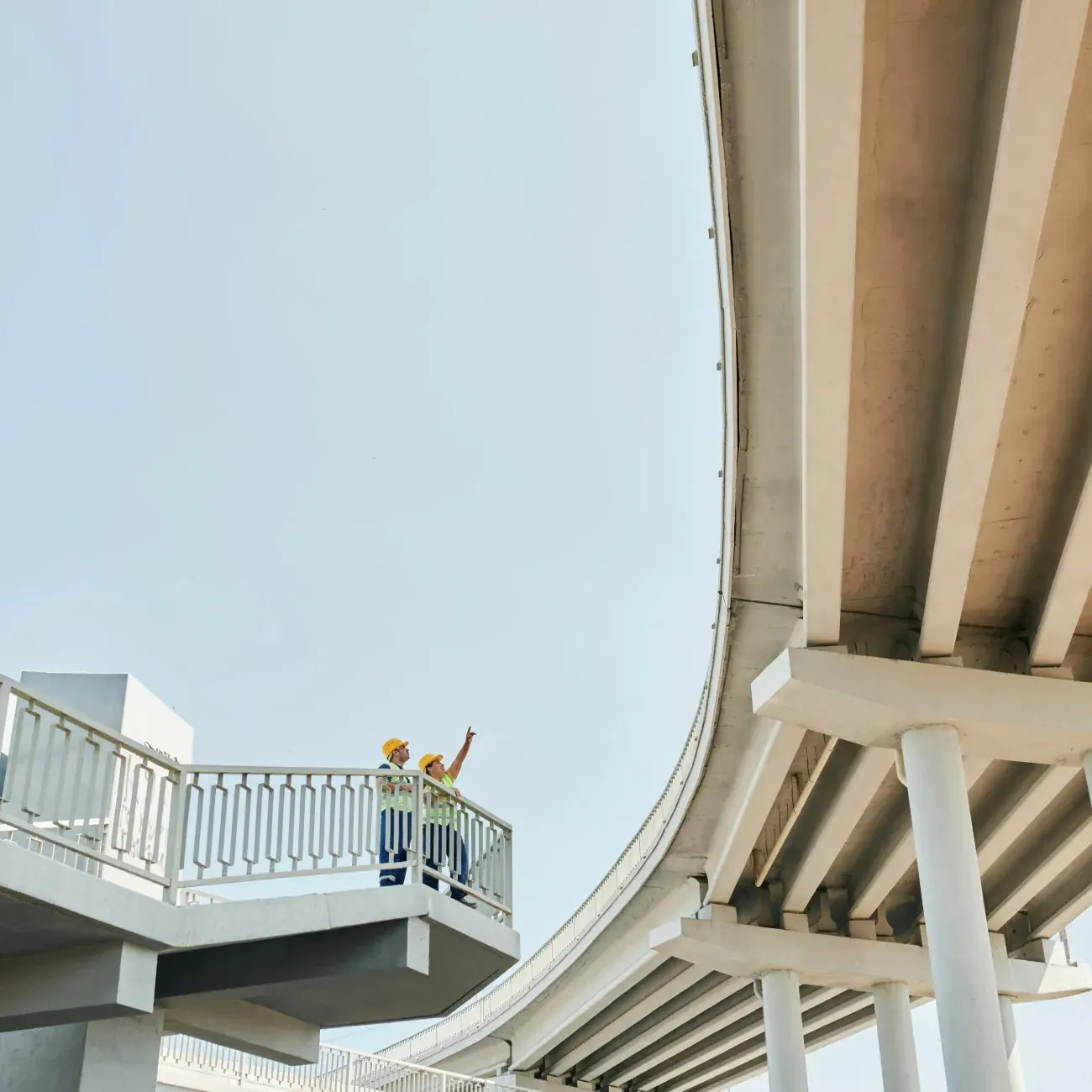 The curving underside of an elevated roadway, seen from below