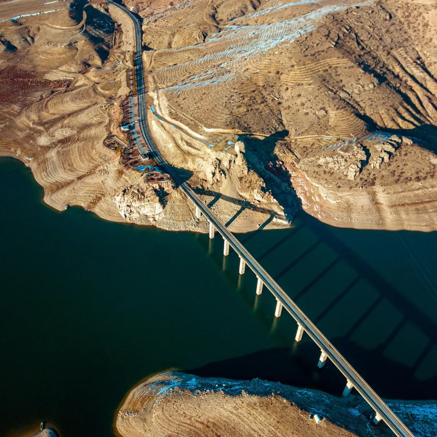 A long road bridge crossing open water