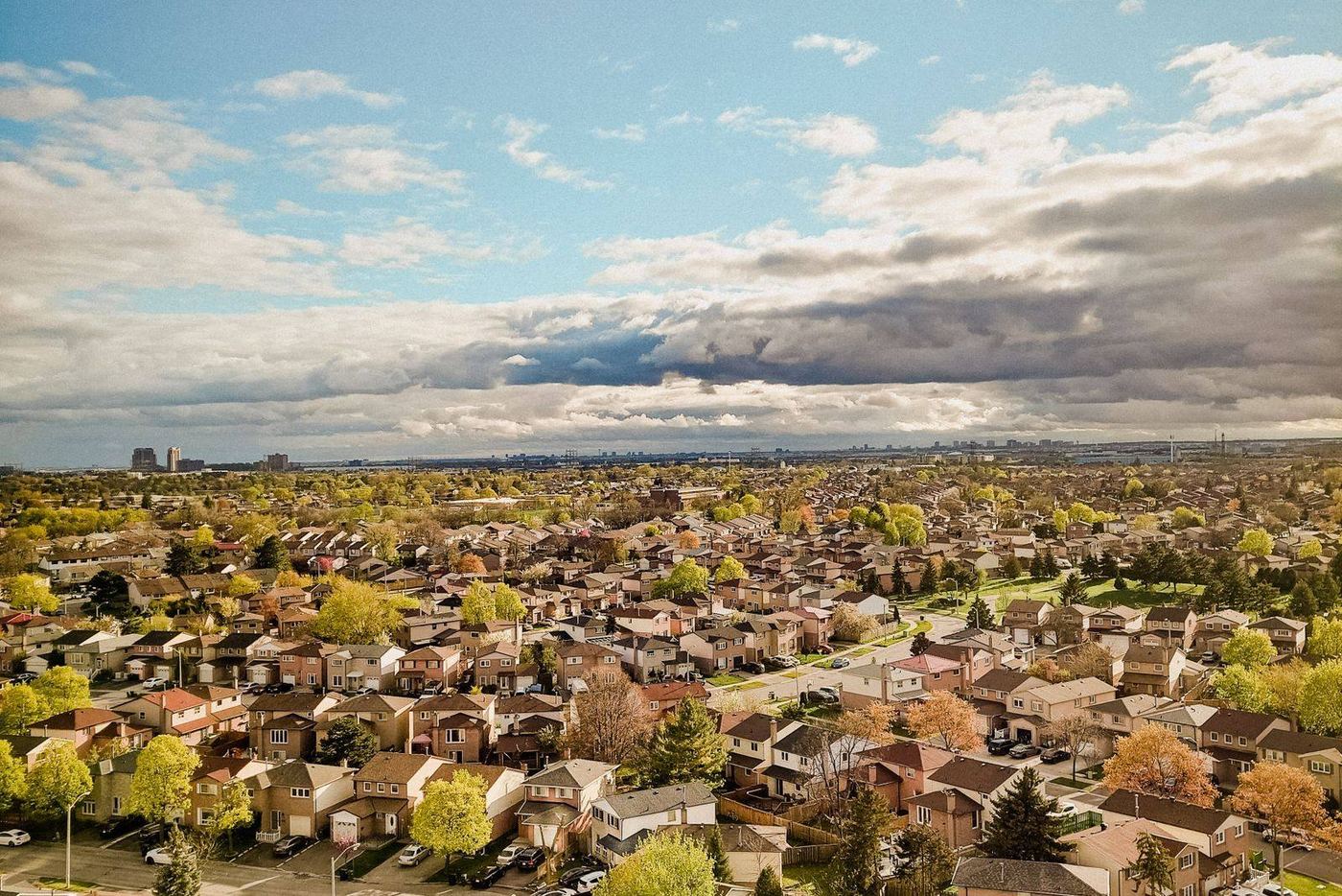 An aerial view of a suburban neighbourhood stretching to the horizon
